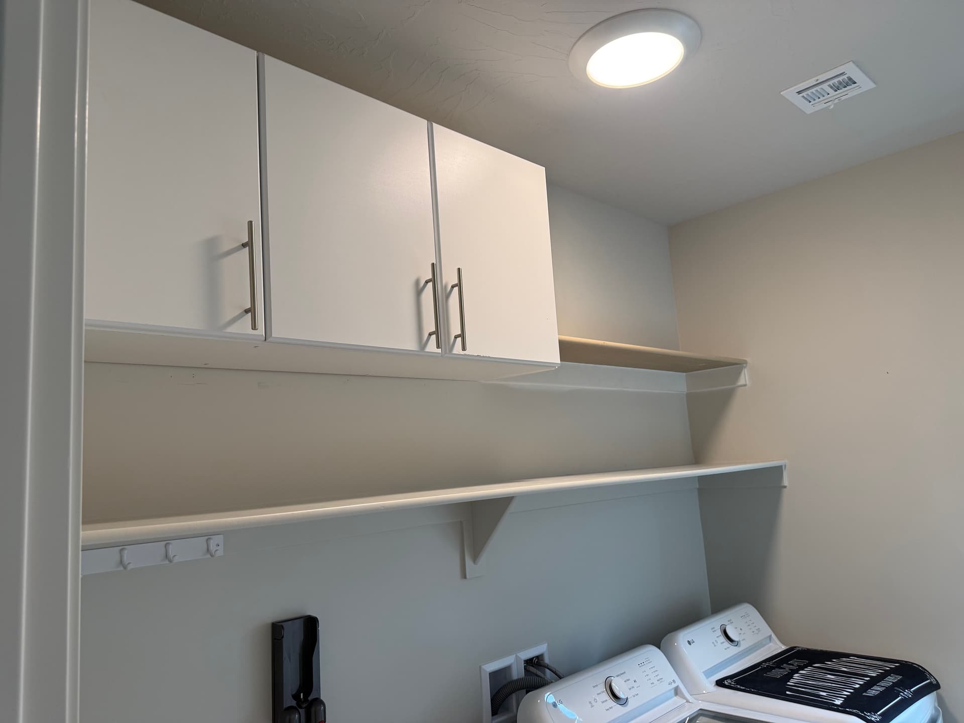 Laundry Room Storage Upgrade with Shelving and Cabinets image